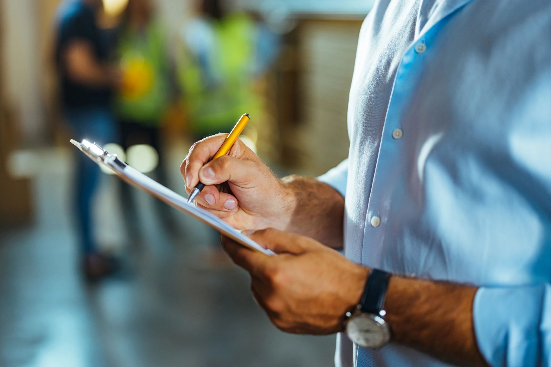 Professional taking notes on a clipboard