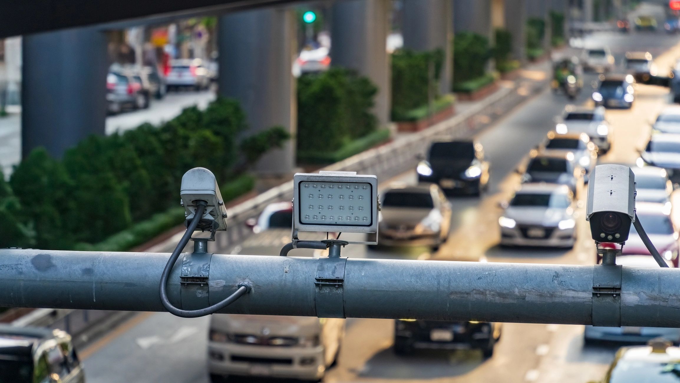 Surveillance cameras monitoring a busy city street